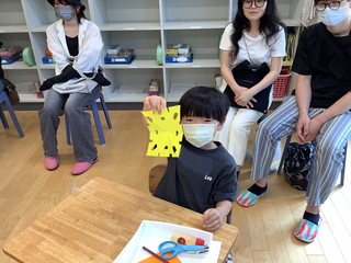 おりがみを見せる男の子