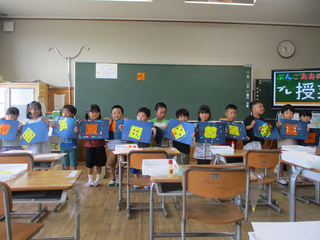 並んで作品を見せるこどもたち